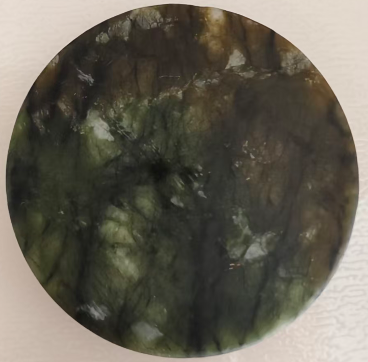 Single round emerald green jade stone disc with rich crystalline texture