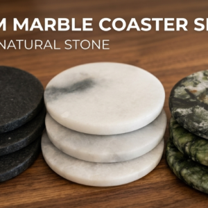 Three natural jade intention stones in deep black, mutton-fat white, and emerald green placed on dark wood desk